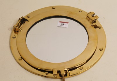 Lot 682 - A modern brass ships porthole type wall mirror,...