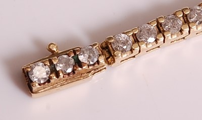 Lot 1121 - A yellow metal diamond tennis bracelet, having...