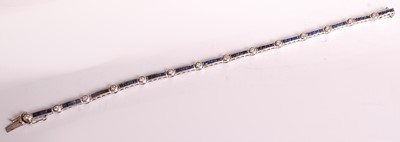 Lot 1122 - An 18ct white gold, sapphire and diamond line...