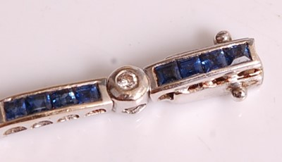 Lot 1122 - An 18ct white gold, sapphire and diamond line...