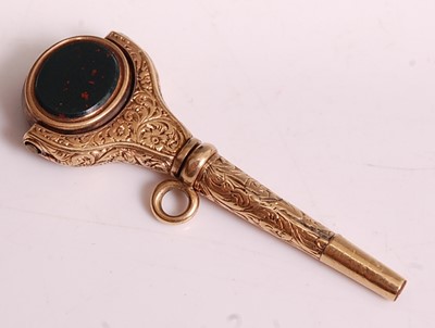 Lot 1154 - A yellow metal engraved swivel fob pendant...