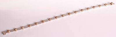 Lot 1123 - An 18ct white and rose gold diamond line...