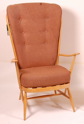 Lot 407 - An Ercol light elm stickback armchair, having...