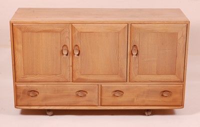 Lot 415 - An Ercol light elm Windsor sideboard, the...