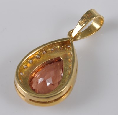 Lot 1126 - A yellow metal, topaz and diamond pear-shaped...