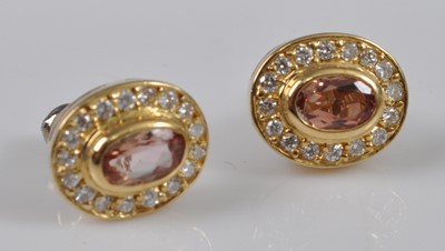 Lot 1125 - A pair of yellow metal, topaz and diamond oval...