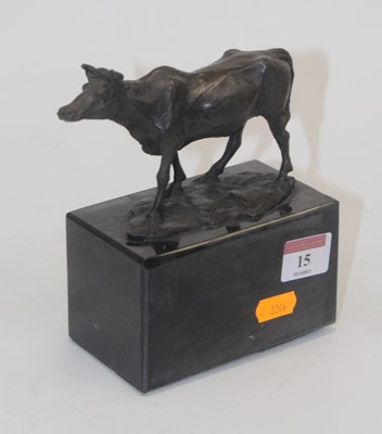 Lot 15 - A modern bronzed metal model of a cow raised...