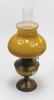 Lot 17 - An early 20th century brass pedestal oil lamp...
