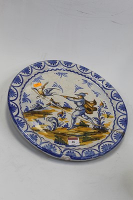 Lot 46 - An early 19th century Delft charger, decorated...