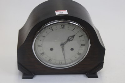 Lot 54 - A 1950s oak cased mantel clock, having a...