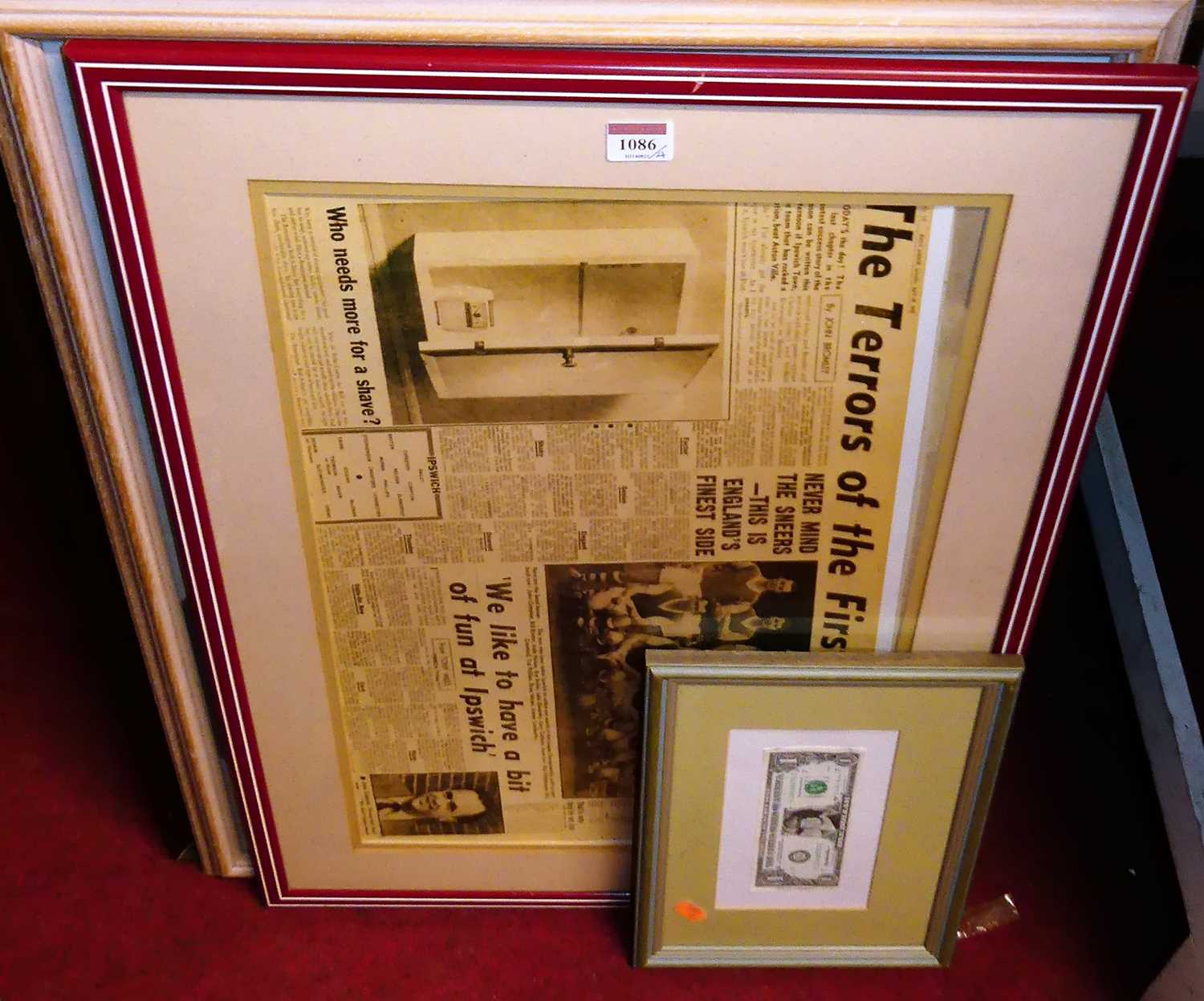Lot 1086 - A framed one dollar bill, a framed newspaper...