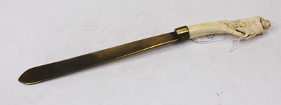 Lot 331 - A circa 1900 brass letter-opener, the ivory...