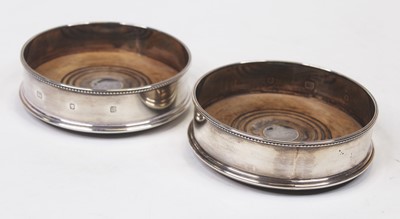 Lot 340 - A pair of modern silver bottle coasters, each...