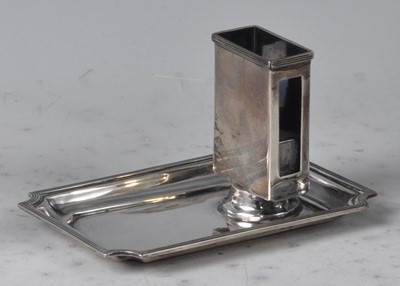 Lot 122 - An Art Deco silver matchbox holder, raised on...