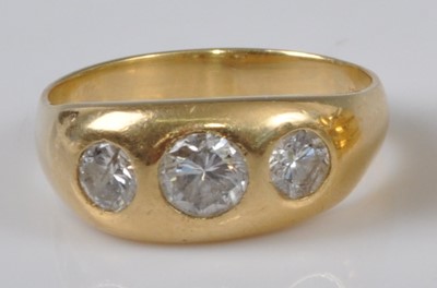 Lot 1146 - A yellow metal diamond three stone ring,...