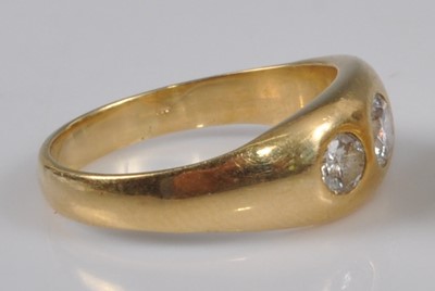 Lot 1146 - A yellow metal diamond three stone ring,...