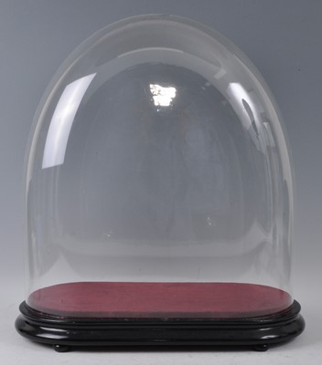 Lot 1197 - A Victorian glass dome on ebonised plinth, h.56cm