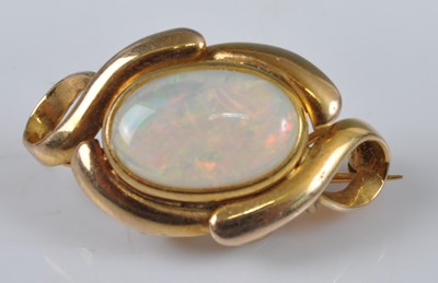 Lot 1140 - A yellow metal opal brooch, featuring an oval...