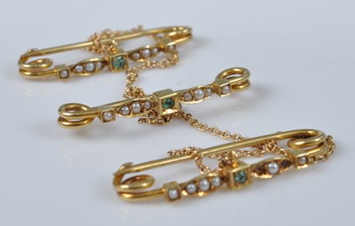 Lot 1143 - A set of three yellow metal, emerald and seed...
