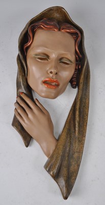 Lot 64 - An Art Deco painted plaster wall-mounted mask,...