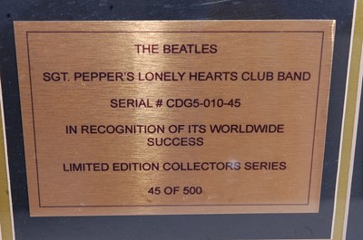 Lot 669 - The Beatles, a gold disc to for the album Sgt....