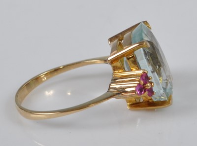 Lot 1117 - A yellow metal, aquamarine and ruby dress ring,...