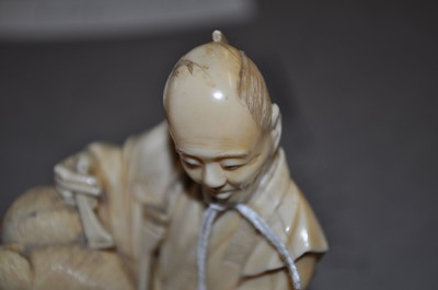 Lot 1238 - A Japanese Meiji period carved ivory okimono...