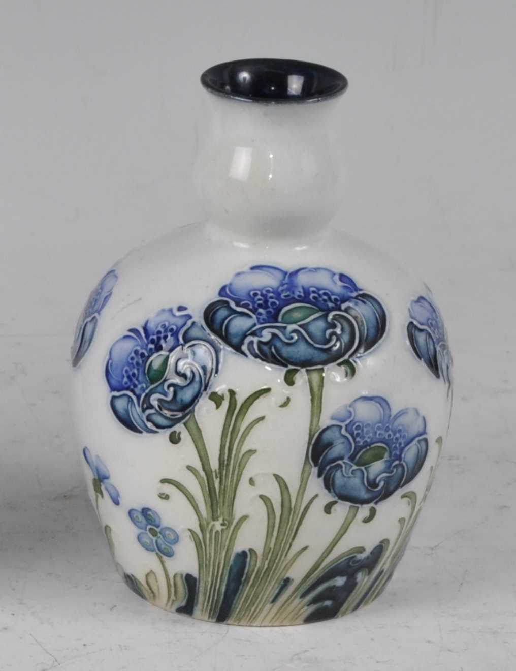 Lot 34 - A Moorcroft Florian ware miniature squat vase,...