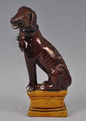 Lot 1227 - A Chinese Kangxi period stoneware dog, on...