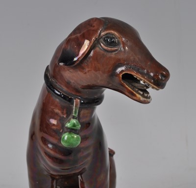Lot 1227 - A Chinese Kangxi period stoneware dog, on...