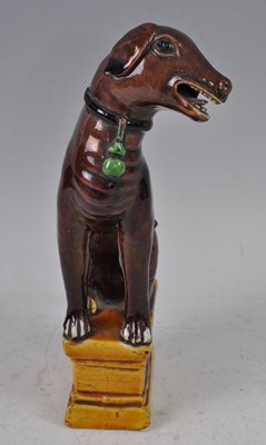 Lot 1227 - A Chinese Kangxi period stoneware dog, on...