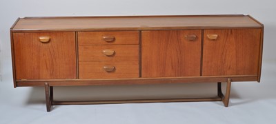 Lot 444 - A 1960s teak long sideboard, having three...