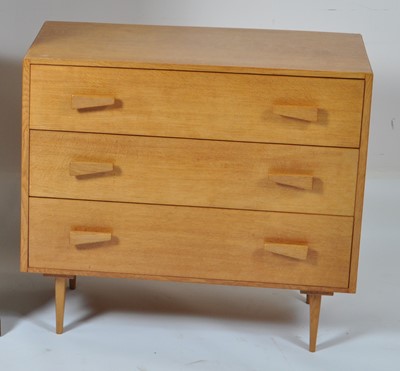 Lot 398 - A 1950s light oak low chest of three long...