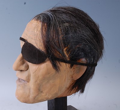 Lot 692 - A life sized painted plaster model head of...