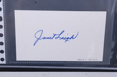 Lot 696 - A red autograph album containing over 50...