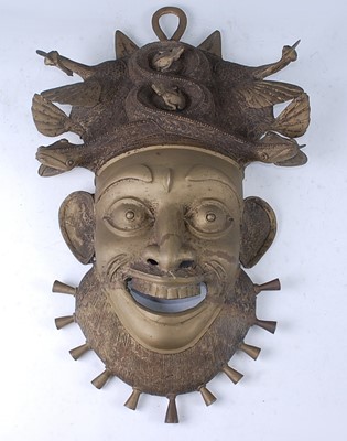 Lot 146 - A large cast brass wall mask, in the form of a...