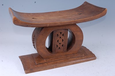 Lot 149 - An Asante carved hardwood stool, the shaped...