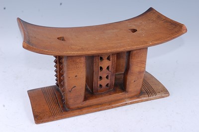 Lot 149 - An Asante carved hardwood stool, the shaped...