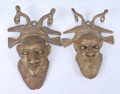 Lot 154 - A near pair of lost wax brass mask form...
