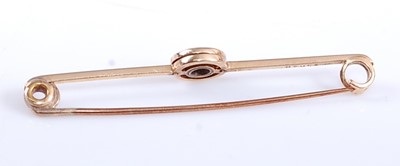 Lot 2562 - A yellow metal diamond bar brooch, featuring a...