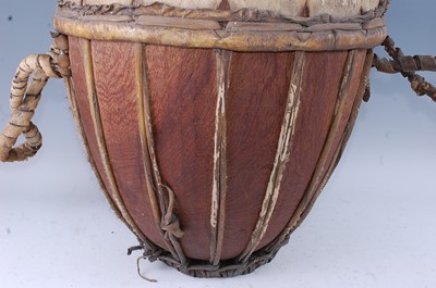 Lot 157 - A large African drum, the hide stretched over...