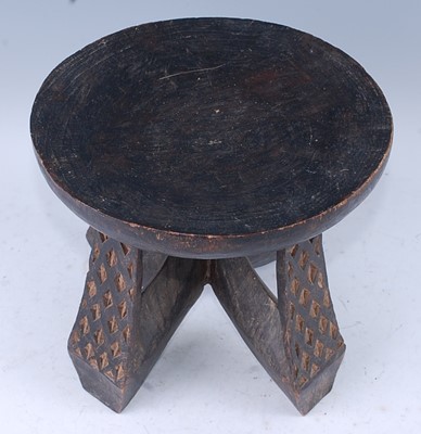 Lot 159 - A West African hardwood stool, the circular...