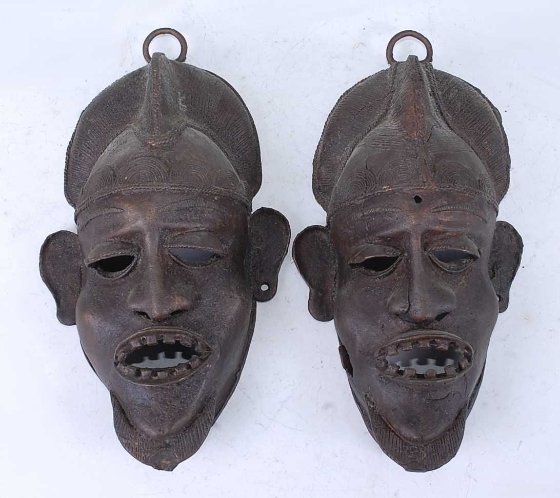 Lot 163 - A pair of cast copper alloy wall masks, each...