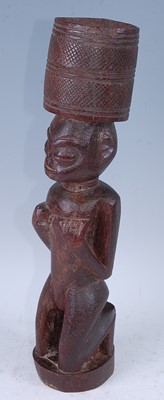 Lot 176 - A Bateba Phuwe, carved in kneeling pose with...