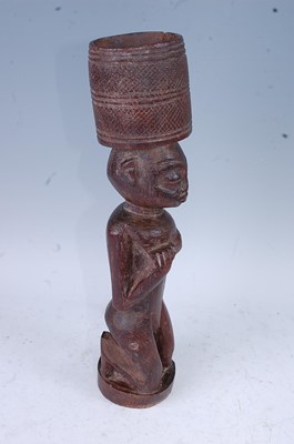 Lot 176 - A Bateba Phuwe, carved in kneeling pose with...