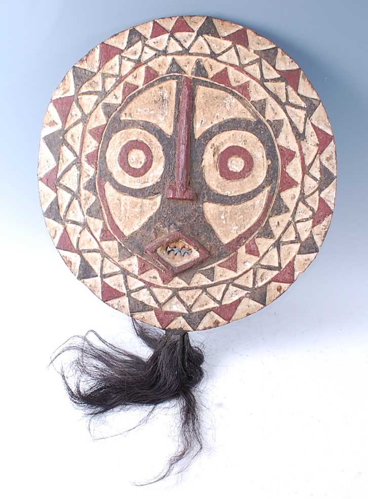 Lot 180 - A carved wooden "Owl" mask, of circular form...