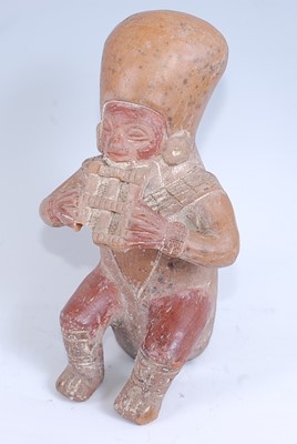 Lot 350 - A pottery figure, modelled as a male musician...