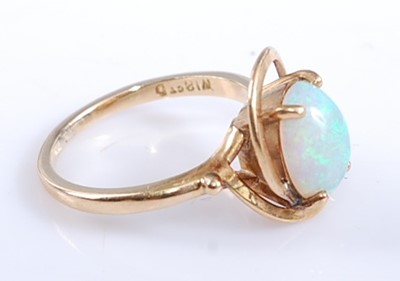 Lot 2573 - A yellow metal opal dress ring, comprising an...
