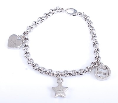 Lot 2574 - A Gucci sterling silver charm bracelet, with a...