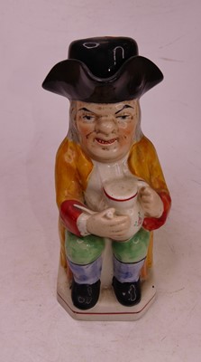 Lot 36 - A Staffordshire style pottery Toby jug, in the...
